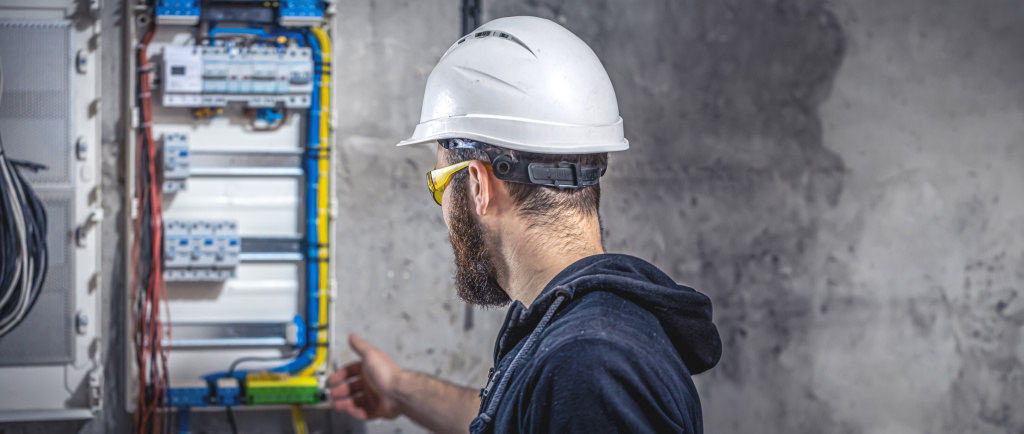 male-electrician-works-switchboard-with-electrical-connecting-cable (1).jpg